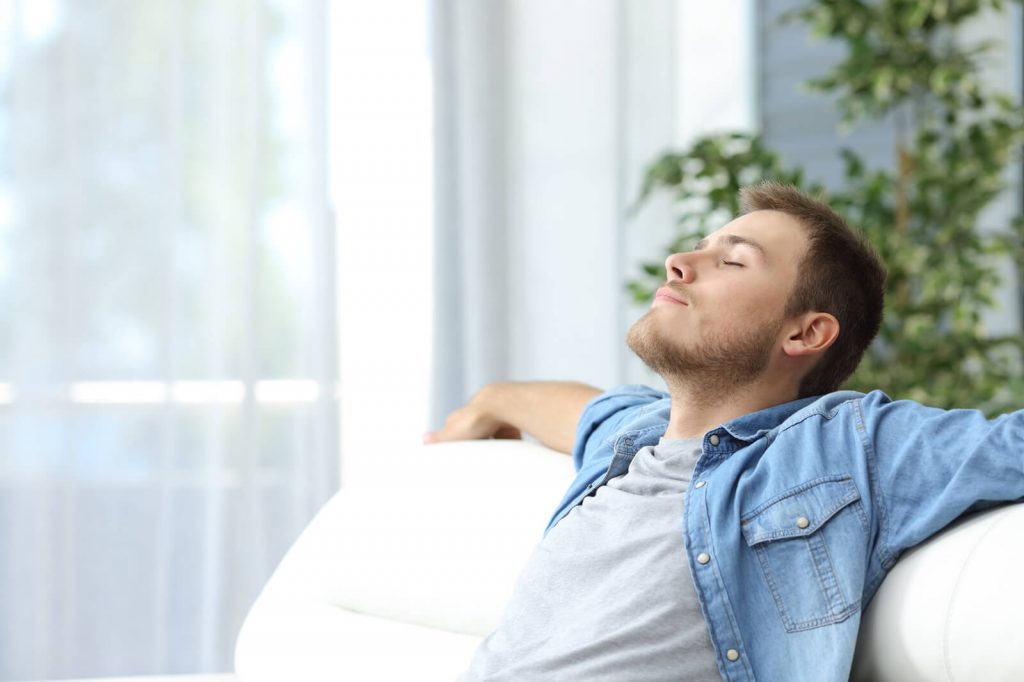 Man relaxing on couch at home