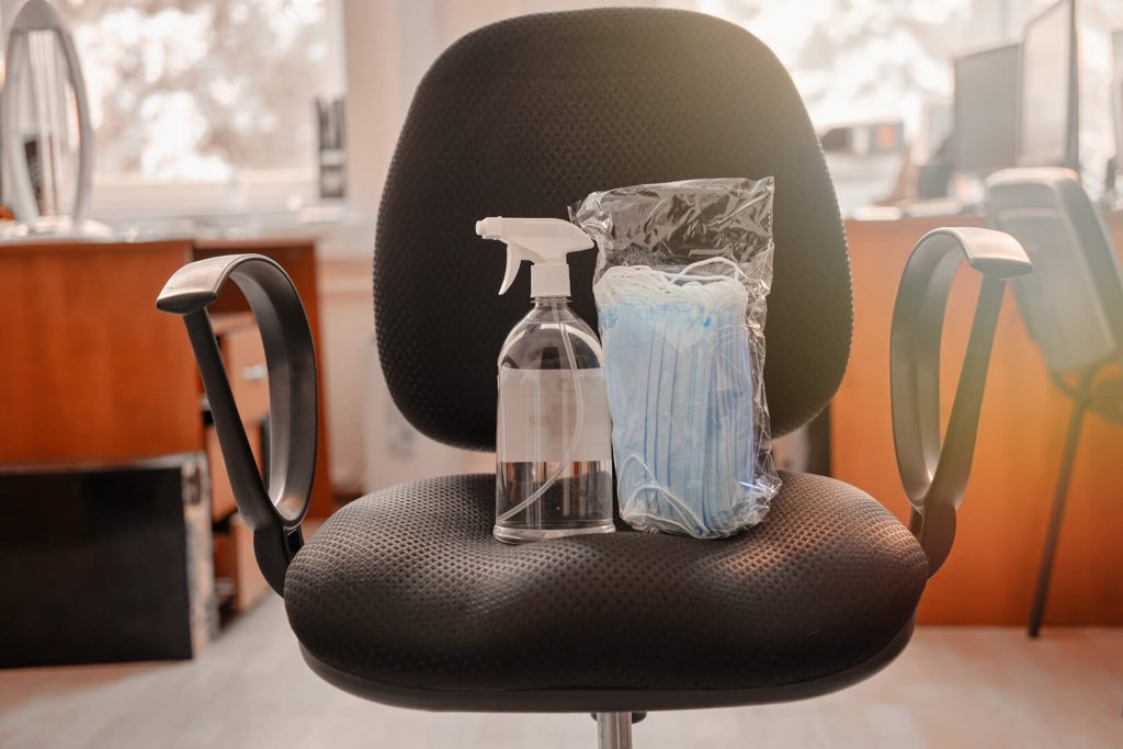 sanitizer and masks on office chair