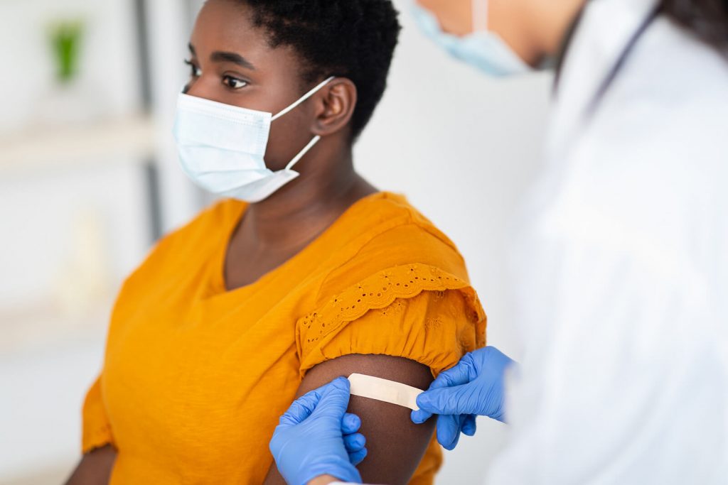 woman getting a bandage after vaccination