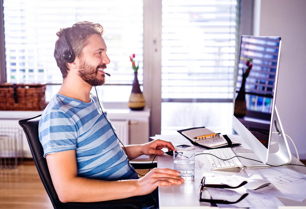 Man happily working at a computer