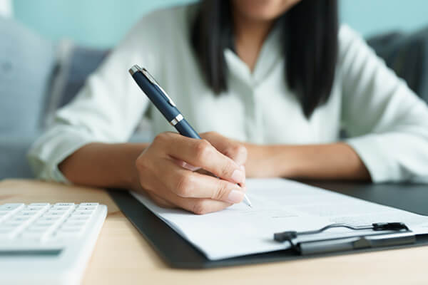 woman signing an agreement