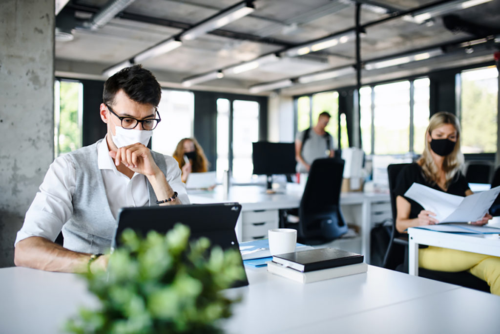 Modern office with masked employees