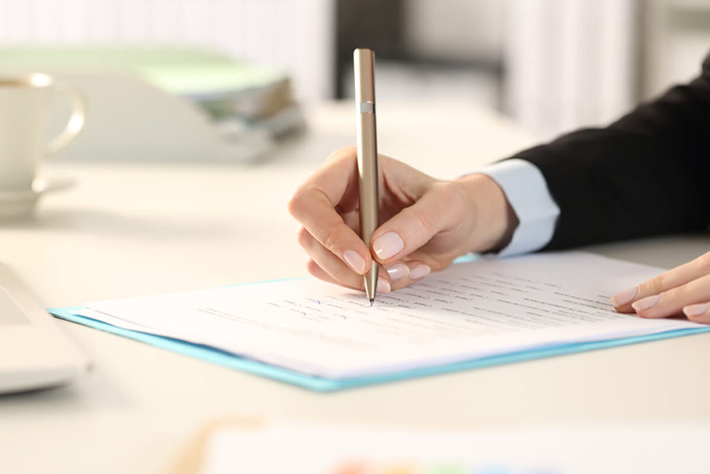 Close up of woman filling out form