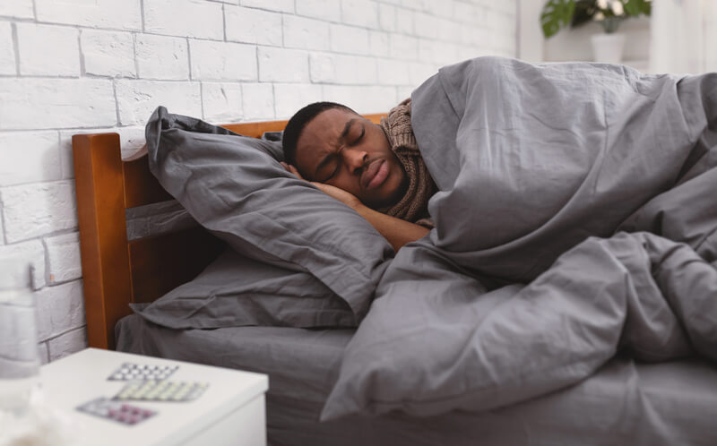 Man at home sick in bed