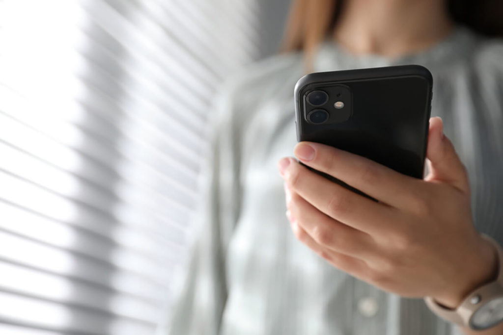 woman at home alone looking at phone