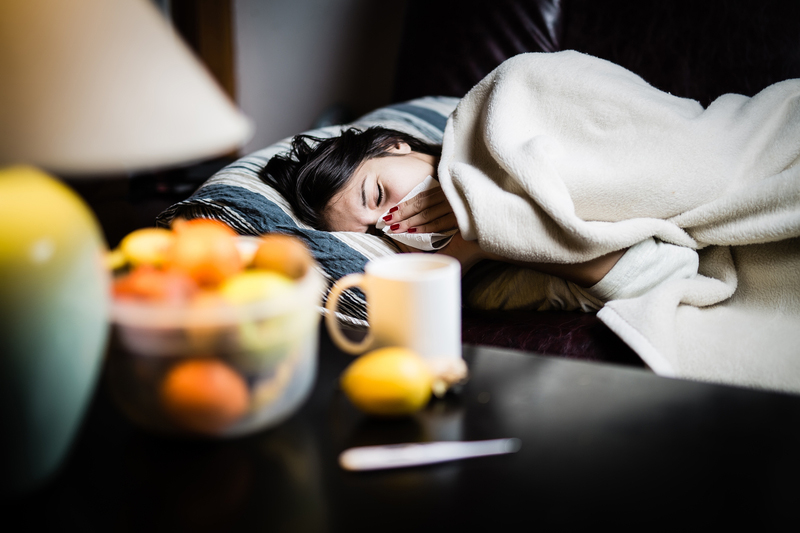 woman home sick from work in bed