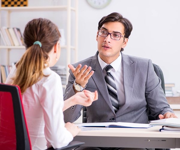 woman and man discussing topic in office