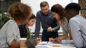group around a table working on a document
