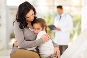 woman hugging sick daughter