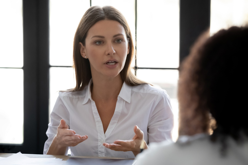 woman having serious conversation with coworker