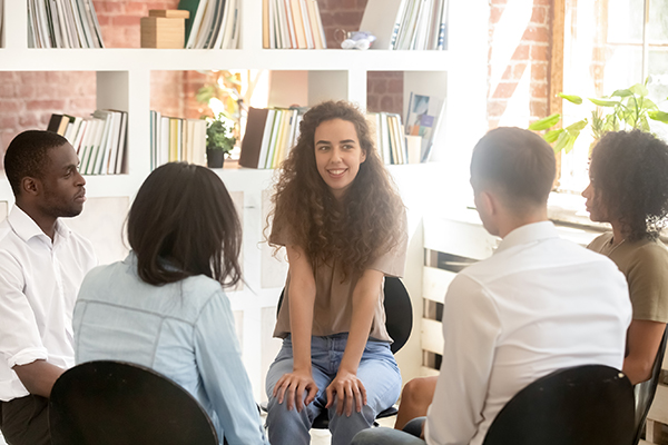 employees in a discussion sitting in a circle