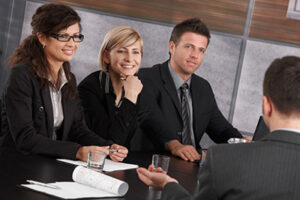 a group of colleagues talking around a table